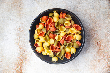 pasta conchiglie raw colored mix  meal food snack on the table copy space food background