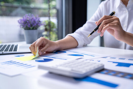 financial business woman calculating corporate income tax data and analyze financial stock charts that are in good shape with growth and progress. financial investment and accounting analysis