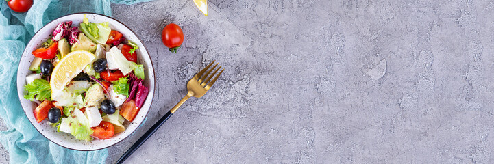 Fresh salad with tomato, lettuce, avocado, olives, feta and pepper. Diet eating