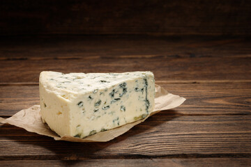 Tasty blue cheese on wooden table.