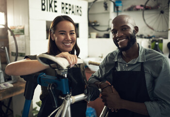 We put your bike first in here. Shot of two young business owners standing together in their...