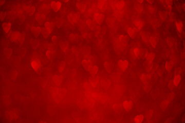 Fototapeta na wymiar Red hearts, sparkling glitter bokeh background, valentines day abstract defocused texture