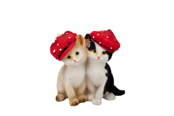 Beautiful souvenir kittens. in a little red riding hood. the toys are made of porcelain. ceramics. and plaster. with rhinestones. On an isolated white background. close-up.