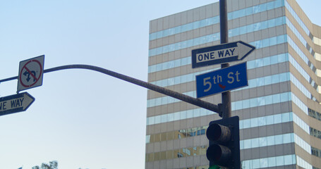 Traffic lights road signs hanging over street. Traffic regulation in city.