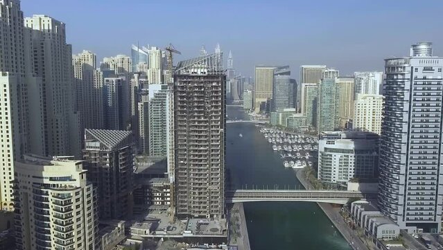 Dubai, UAE. Aerial view of Dubai Marina skyscrapers and river from drone