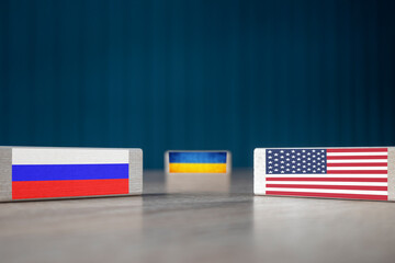 Fototapeta na wymiar State flags of Russian Federation, USA and Ukraine are located on wooden rectangles. Negotiations.The concept is the development of relations between the countries because of the situation in Ukraine.