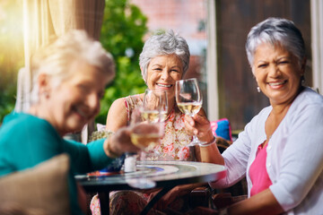 We have a lifetime of toasts. Cropped portrait of a group of senior female friends toasting during a lunch date.
