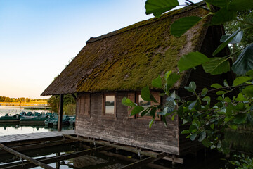 Fototapeta na wymiar Romantic, old boathouse with landing stage, Seeburger See, Lower Saxony, Germany