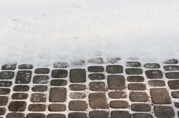 the surface of a pavement covered with a new snow