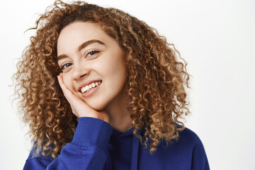 Beauty and wellbeing. Close up portrait of beautiful curly girl with perfect, healthy face,...