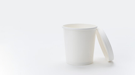 White paper cup with a lid on a light background. copyspace. The concept of eco-friendly paper...