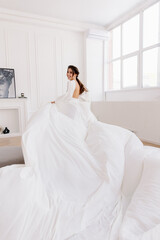 Fototapeta na wymiar A woman in a white airy dress runs and looks back.
