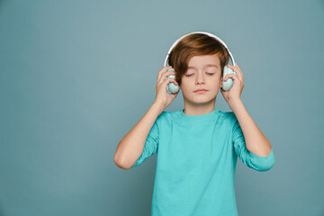 Ginger white boy listening music with headphones