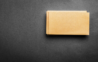 Stack of blank golden business card on grey background. Blank name card.
