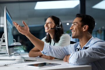 Delivering service youve never seen before. Shot of a young man and woman using a computer while working in a call centre.
