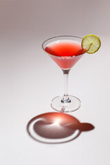 Cold alcoholic or non-alcoholic cocktail on pastel background. Hard light, deep shadow.