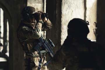 Vulnerable postion of duo soldiers stuck at a building . High quality photo - obrazy, fototapety, plakaty