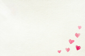 Love background with hearts painted in the low right corner on a recycled white paper for Valentine's Day or other celebrations, letter, copy space