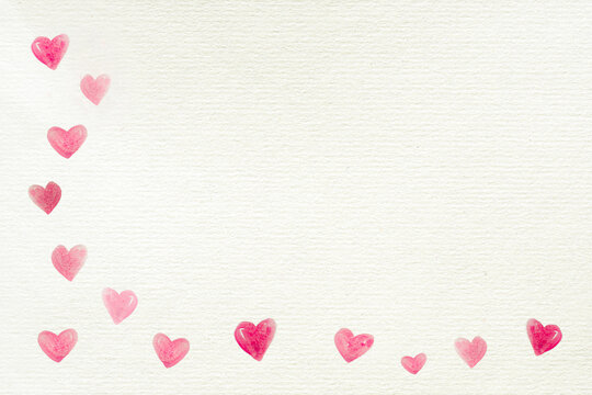 Love background with a frame on the left side made by many hearts painted on a recycled white paper for Valentine's Day or other celebrations, letter, copy space