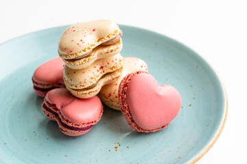 Macarons cakes in a shape of a heart. Small French cakes for Valentines Day. Sweet and colorful french macaroons.