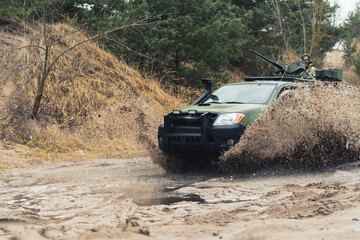 Fototapeta na wymiar Heavy duty patrol truck gears getting dirty in mud puddle . High quality photo