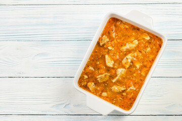 Homemade chicken stew in baking dish.Top view, copy space.