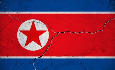 An image of the North Korea flag on a wall with a crack.