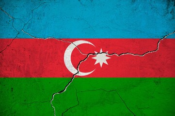 An image of the Azerbaijan flag on a wall with a crack.