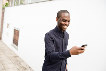 happy African American man looking at mobile phone