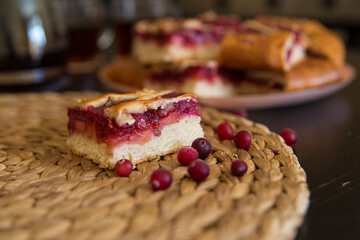 Pieces of a berry pie on a board with tea