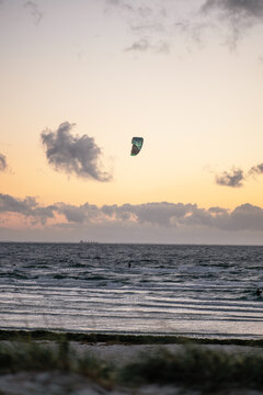 The tourist swimming in the sea on a kiteboard or kitesurfing