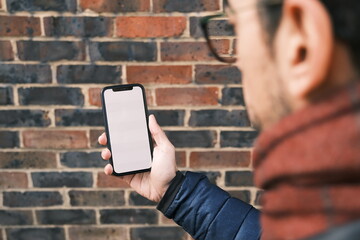 A man holding a smartphone wide-angle