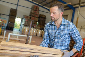 Man carrying lengths of wood