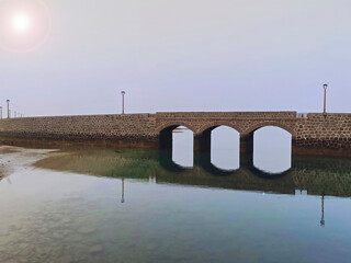 stone bridge over the calm sea