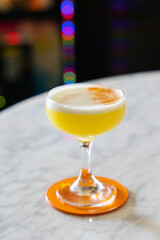 Mezcal pineapple lime cocktail with ginger garnish