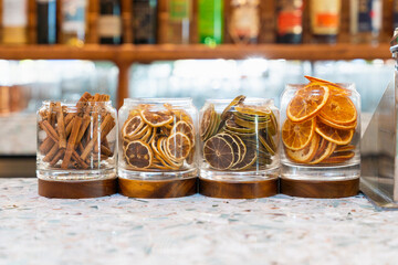 Dried citrus fruits and cinnamon wait to be added to the next cocktail
