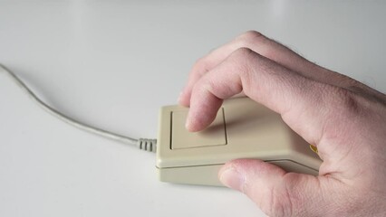 Hand Using a Retro Computer Mouse from 80s 90s Close Up