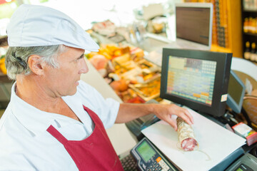 a butcher is weighing produce