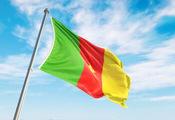 3d rendering Cameroon flag waving in the wind on flagpole. Perspective wiev Cameroon flag waving a blue cloudy sky
