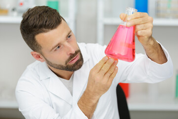 handsome student of chemistry working with chemicals