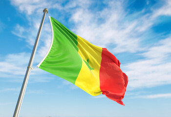 3d rendering Senegal flag waving in the wind on flagpole. Perspective wiev Senegal flag waving a blue cloudy sky