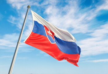 Naklejka na ściany i meble 3d rendering Slovakia flag waving in the wind on flagpole. Perspective wiev Slovakia flag waving a blue cloudy sky