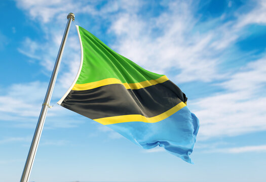 3d rendering Tanzania flag waving in the wind on flagpole. Perspective wiev Tanzania flag waving a blue cloudy sky