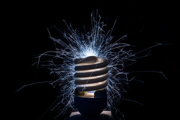 Blue electric sparks from energy saving light bulb