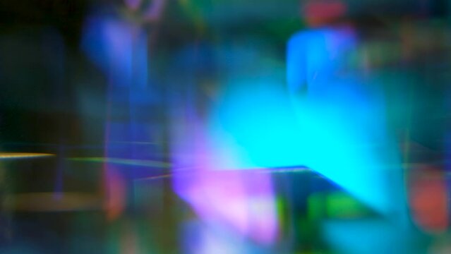 Abstract movement of soft light reflected in a prism, mysterious blurred color reflections