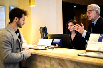 Fototapeta na wymiar Customer checking in at a hotel reception