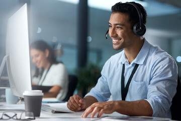 Where would we be without loyal customers like you. Shot of a young man using a headset and...