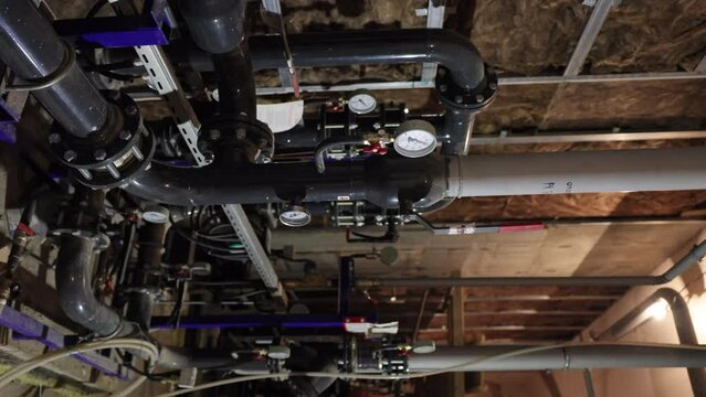 System of pipelines, gauges, sensors and dials in the gas boiler system of the building. Vertical video