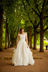 white wedding bride under long path of trees walking and on her knees praying laughinf and enjoying time