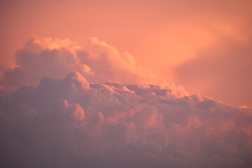 Colorful evening landscape with soft pastel coloured clouds on watercolor tinted sunset sky....